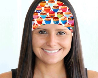 May include: A woman with long brown hair is wearing a white headband with a colorful cupcake pattern.