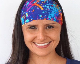 May include: A blue headband with a colorful paint splatter design. The headband is made of a soft, stretchy material and is perfect for keeping hair out of your face.