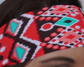 May include: A red, white, and teal patterned headband with a geometric design.