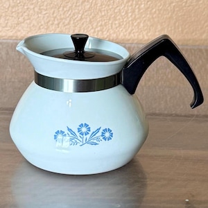 May include: A set of three ceramic mugs with a speckled, matte finish. The mugs are in shades of cream, light gray, and dark gray. Each mug has a simple, minimalist design, perfect for coffee or tea.