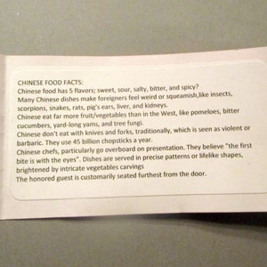 May include: A white card with the text "CHINESE FOOD FACTS" and facts about Chinese cuisine. The card is folded and has the date "10/29/2017" printed on the side.