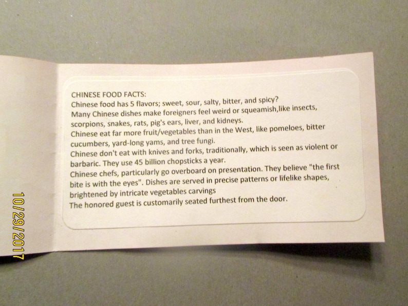 May include: A white card with the text "CHINESE FOOD FACTS" and facts about Chinese cuisine. The card is folded and has the date "10/29/2017" printed on the side.