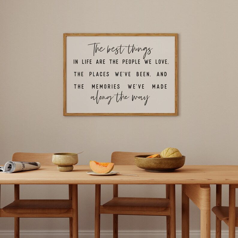 May include: A framed print with a white background and black text that reads "The best things in life are the people we love. The places we've been. And the memories we've made along the way."