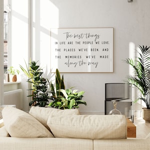 May include: A framed print with a white background and black text that reads "The best things in life are the people we love. The places we've been. And the memories we've made along the way."