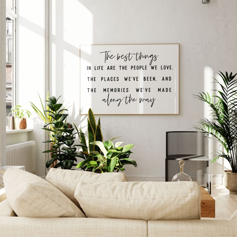 May include: A framed print with a white background and black text that reads "The best things in life are the people we love. The places we've been. And the memories we've made along the way."