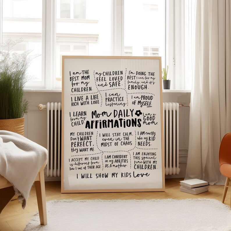 May include: A framed print with the words "Mom Daily Affirmations" in black script. The print includes positive affirmations for mothers, such as "I am the best mom for my children" and "I will show my kids love."