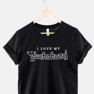 May include: Black t-shirt with white text that says "I love my Dachshund" with a dachshund silhouette.