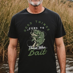 May include: A black t-shirt with a green and white graphic of a fish on a hook. The text on the shirt reads "Good Things Come To Those Who Bait."
