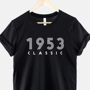 May include: Black t-shirt with white text that reads "1953 CLASSIC".