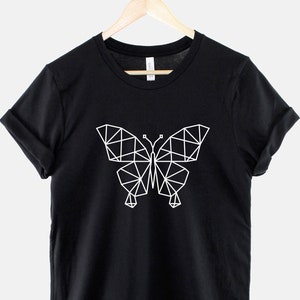 May include: Black t-shirt with a white geometric butterfly design.