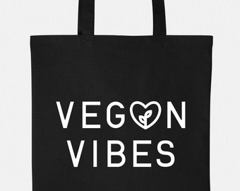 May include: Black tote bag with white text that reads "VEGON VIBES" with a heart and a leaf inside the heart.