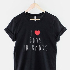 May include: Black t-shirt with white text that reads "I &hearts; BOYS IN BANDS".