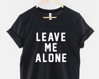 May include: Black t-shirt with white text that reads "LEAVE ME ALONE".