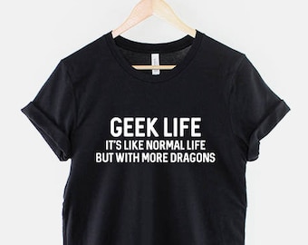 May include: Black t-shirt with white text that reads "Geek Life It's like normal life but with more dragons."