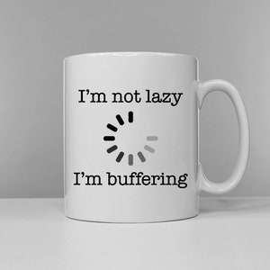 May include: White ceramic mug with black text that reads "I'm not lazy I'm buffering" and a loading icon.
