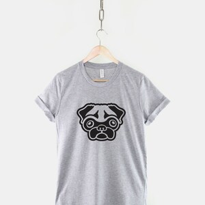 May include: A gray t-shirt with a black pug illustration on the front.