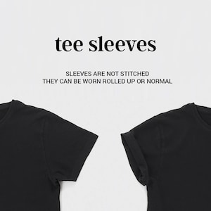 May include: Two black t-shirts with short sleeves. The sleeves on the right shirt are rolled up. The text "tee sleeves" and "Sleeves are not stitched. They can be worn rolled up or normal" is printed above the shirts.