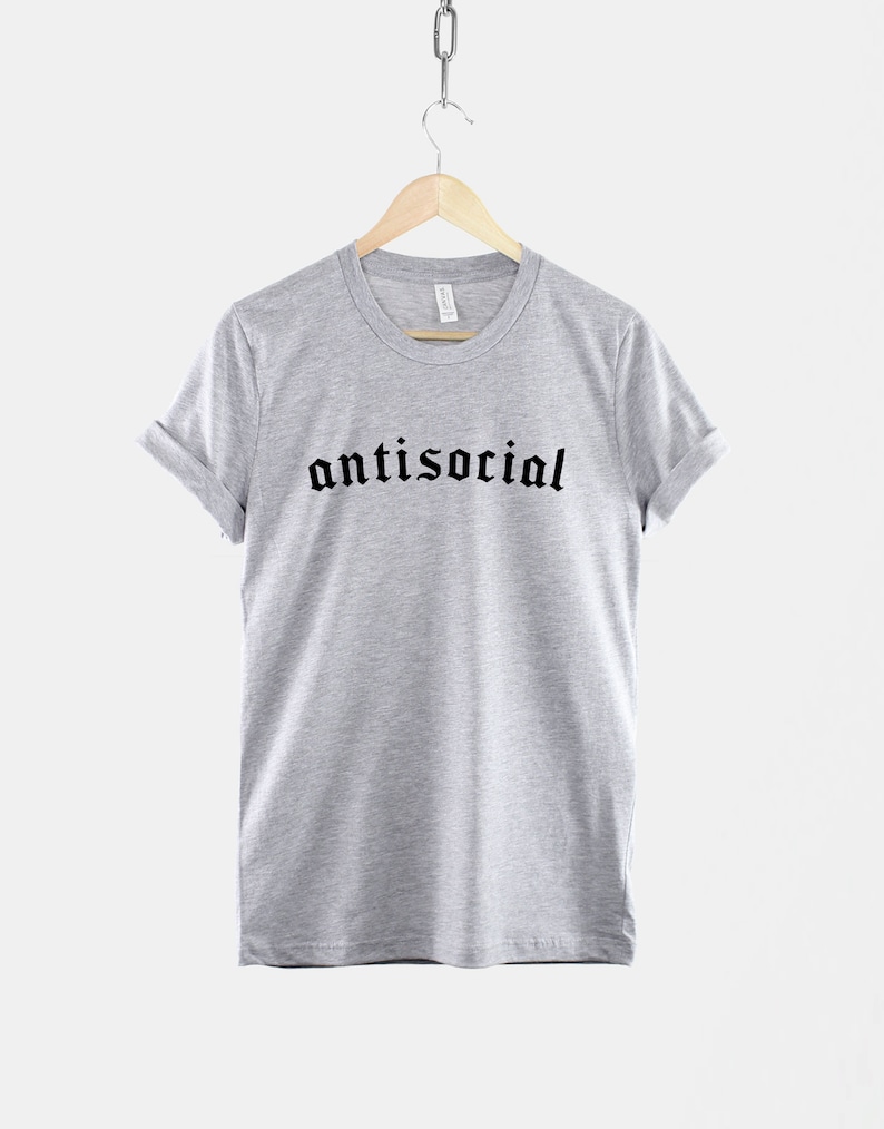May include: A heather grey t-shirt with the word "antisocial" printed in black gothic font.