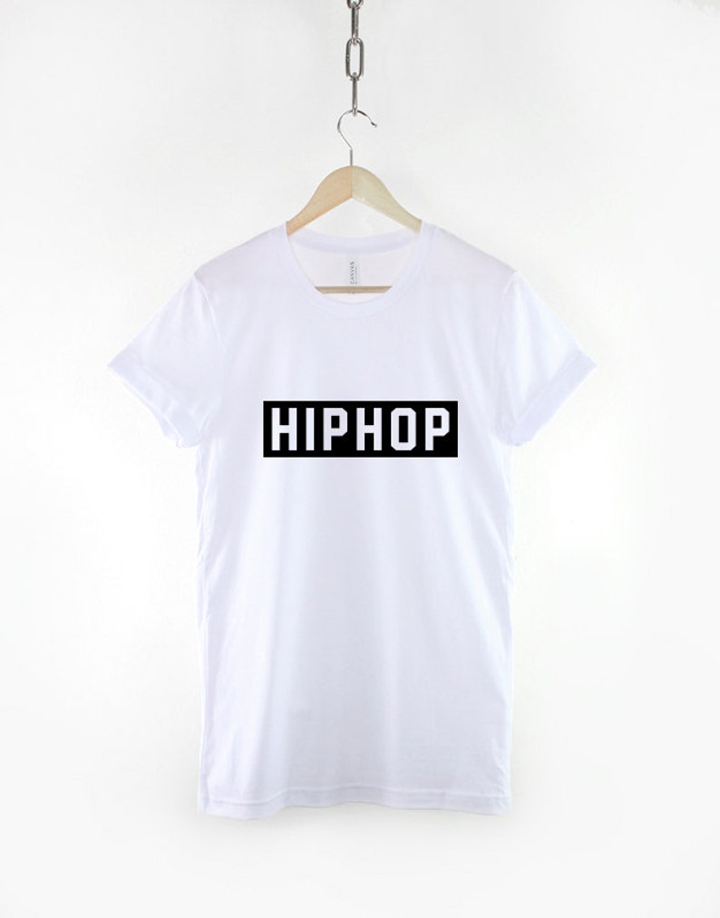 May include: White t-shirt with black text that says "HIPHOP" in a rectangle.