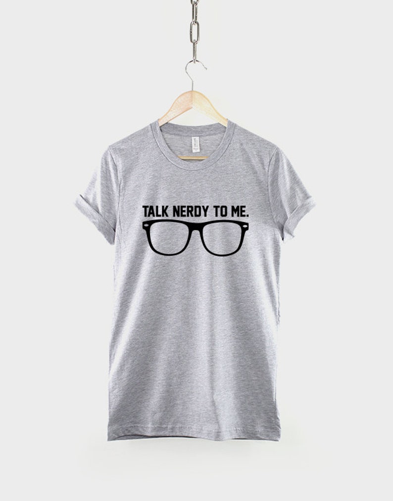 May include: Gray t-shirt with the text "TALK NERDY TO ME." and a pair of black eyeglasses.