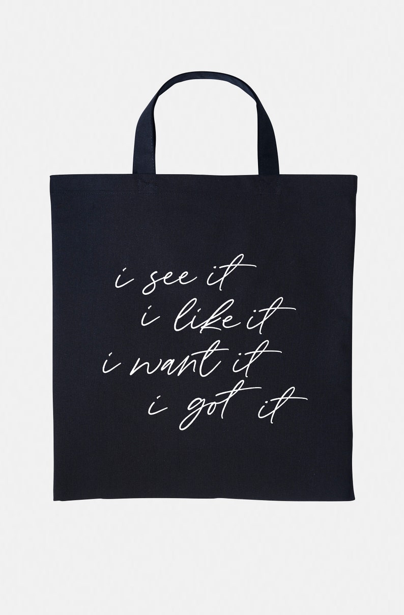 May include: Black tote bag with white text that reads "i see it i like it i want it i got it".