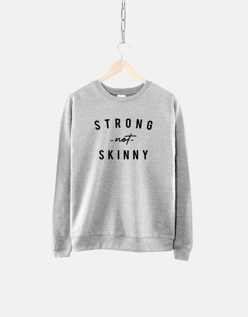May include: Gray sweatshirt with the text "STRONG -not- SKINNY" printed on the front.