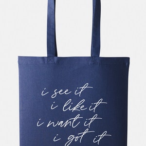 May include: A navy blue tote bag with white text that reads "i see it i like it i want it i got it".