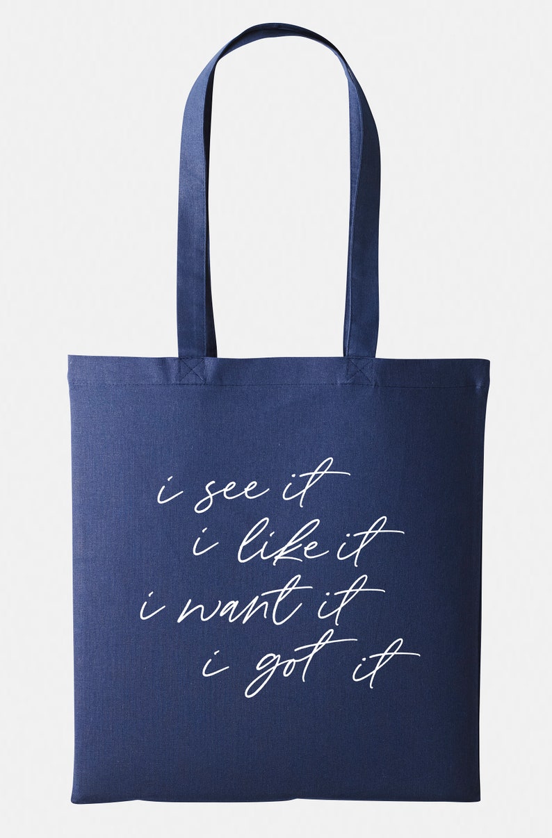 May include: A navy blue tote bag with white text that reads "i see it i like it i want it i got it".