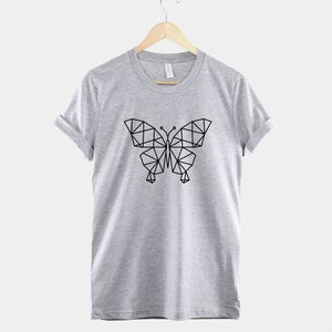 May include: A gray t-shirt with a geometric butterfly design printed in black on the front.