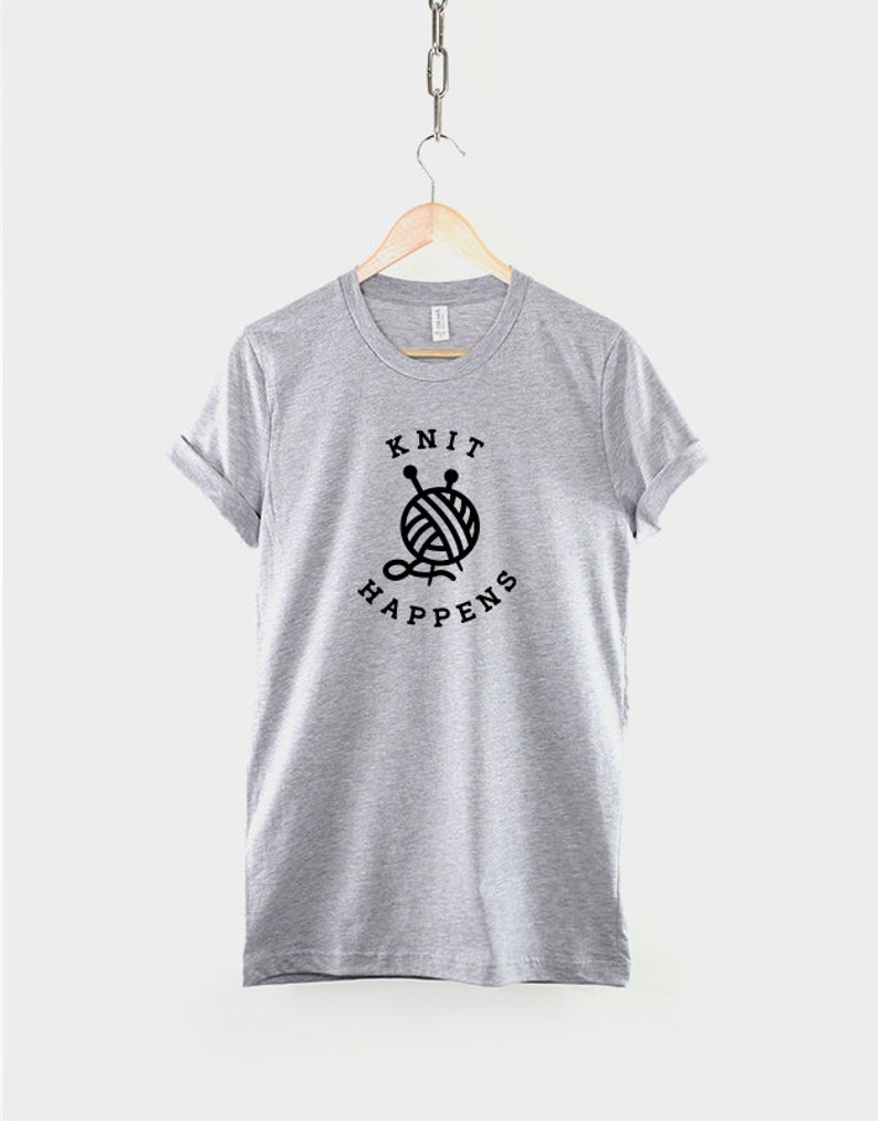 May include: Gray t-shirt with black text that reads "Knit Happens" and a graphic of a ball of yarn with knitting needles.