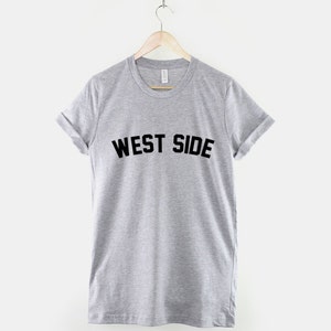 May include: A gray t-shirt with the text "WEST SIDE" printed in black on the front.