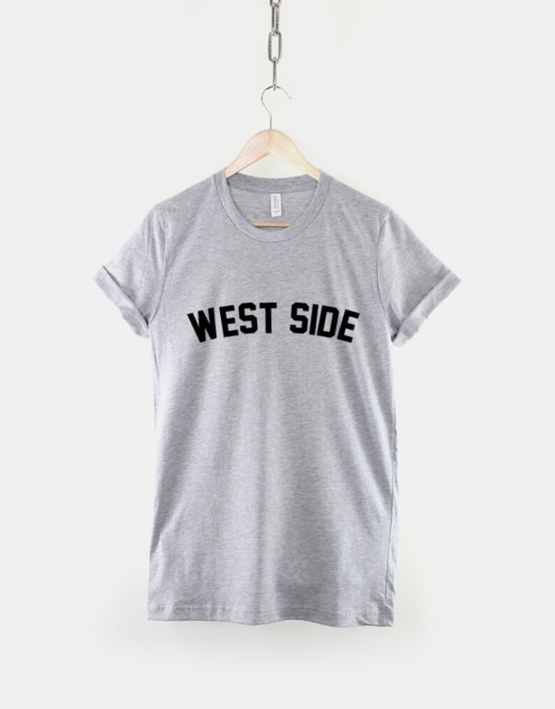 May include: A gray t-shirt with the text "WEST SIDE" printed in black on the front.