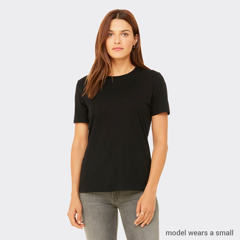 May include: A black short-sleeved t-shirt with a crew neck. The model is wearing a size small.