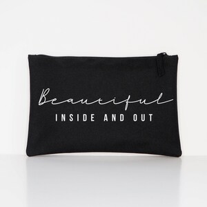 May include: Black canvas zippered pouch with white text that reads "Beautiful Inside and Out".