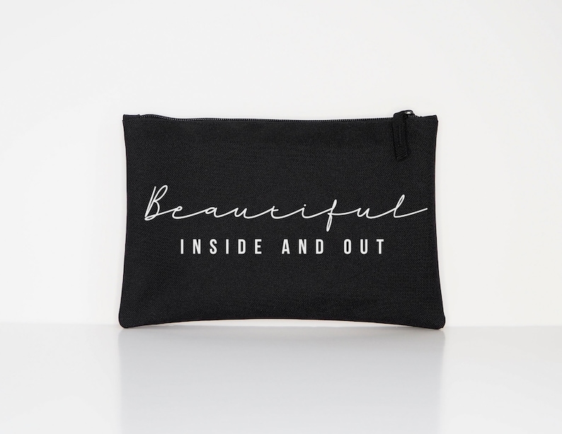 May include: Black canvas zippered pouch with white text that reads "Beautiful Inside and Out".