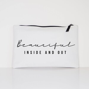 May include: White canvas zippered pouch with black zipper and black text that reads "Beautiful Inside and Out".