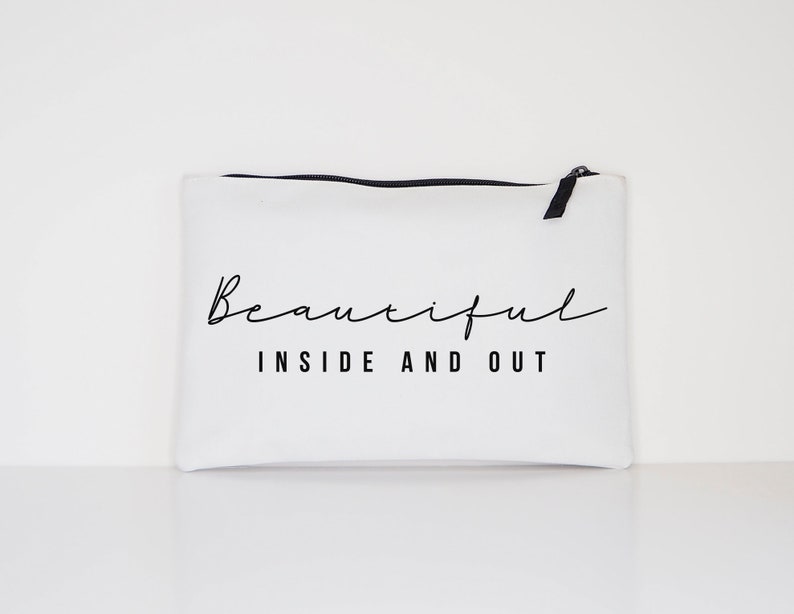 May include: White canvas zippered pouch with black zipper and black text that reads "Beautiful Inside and Out".