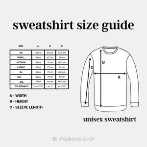 May include: A size chart for unisex sweatshirts with measurements in centimeters for width, height, and sleeve length. The chart includes sizes XS, Small, Medium, Large, XL, 2XL, and 3XL. A tolerance of +/- 0.75 inches is indicated for width and sleeve length, and +/- 1 inch for height.