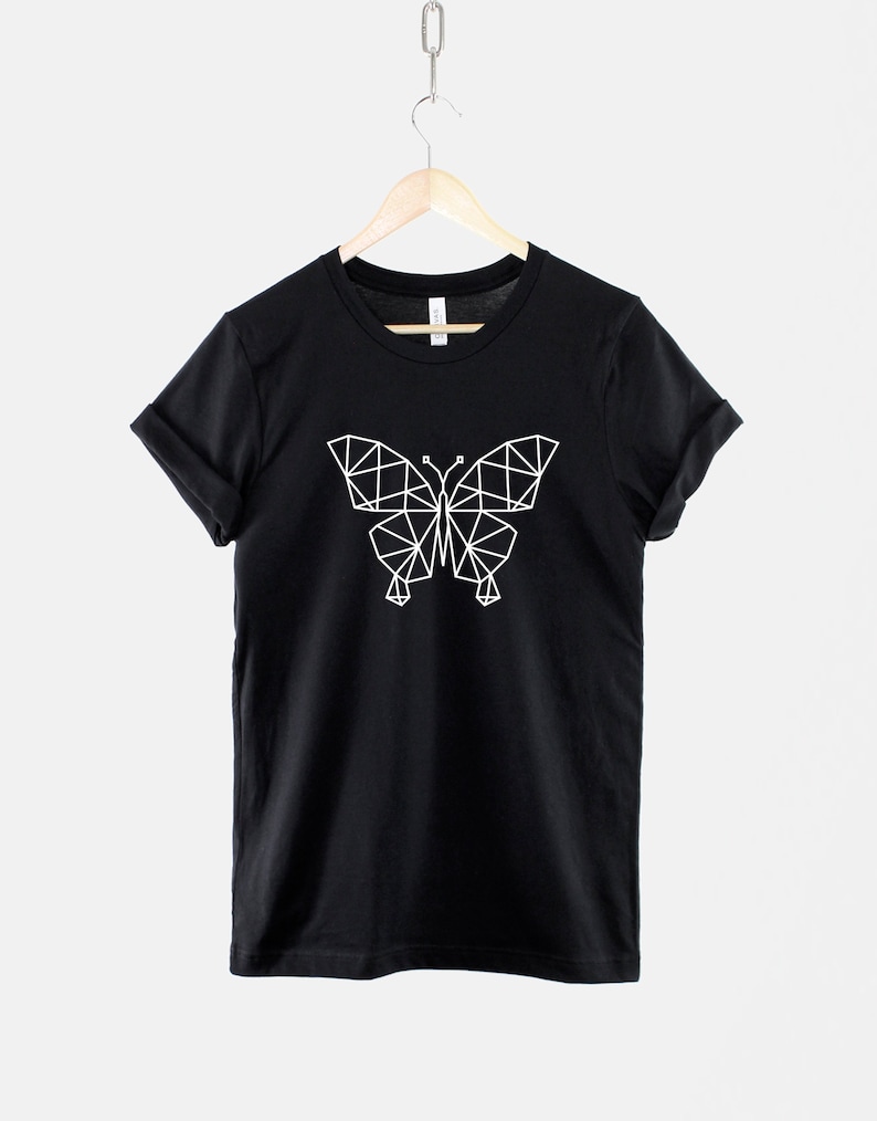 May include: Black t-shirt with a white geometric butterfly design.
