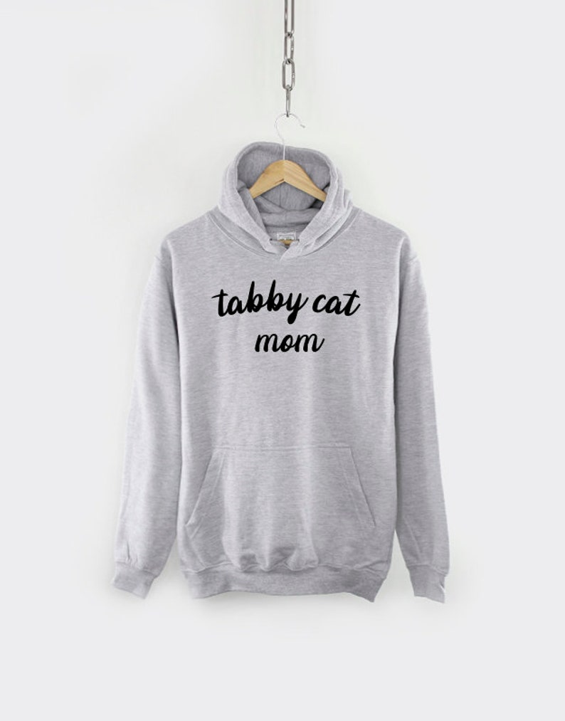 May include: Gray hooded sweatshirt with the text "tabby cat mom" in black lettering.