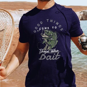 May include: A navy blue t-shirt with a graphic of a fish on a hook and the text "Good things come to those who bait".