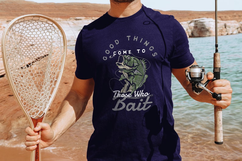 May include: A navy blue t-shirt with a graphic of a fish on a hook and the text "Good things come to those who bait".