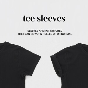 May include: Two black t-shirts with sleeves that are not stitched. The text "tee sleeves" and "Sleeves are not stitched. They can be worn rolled up or normal" is printed on a white background.