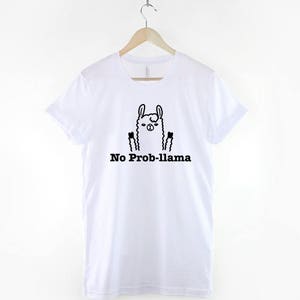 May include: White t-shirt with a black and white illustration of a llama with the text "No Prob-llama" printed on the front.
