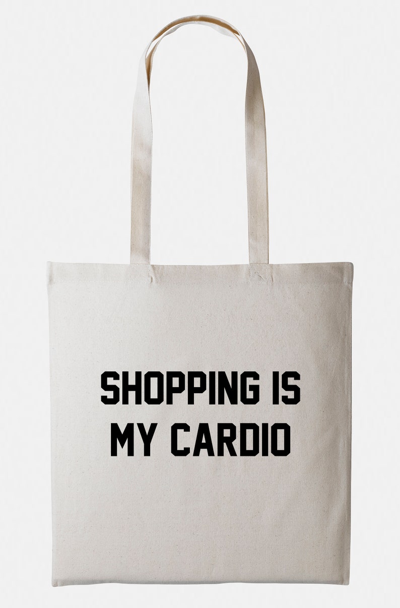 May include: A white canvas tote bag with black text that reads "SHOPPING IS MY CARDIO".