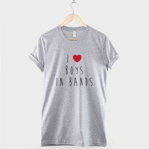 May include: A heather grey t-shirt with a red heart and the text "I &hearts; BOYS IN BANDS" printed on the front.