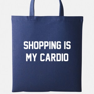 May include: A navy blue tote bag with white text that reads "SHOPPING IS MY CARDIO".