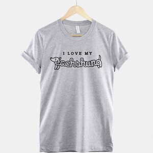 May include: A heather grey t-shirt with a black graphic of a dachshund and the text "I love my dachshund".