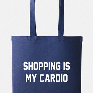 May include: A navy blue tote bag with white text that reads "SHOPPING IS MY CARDIO".