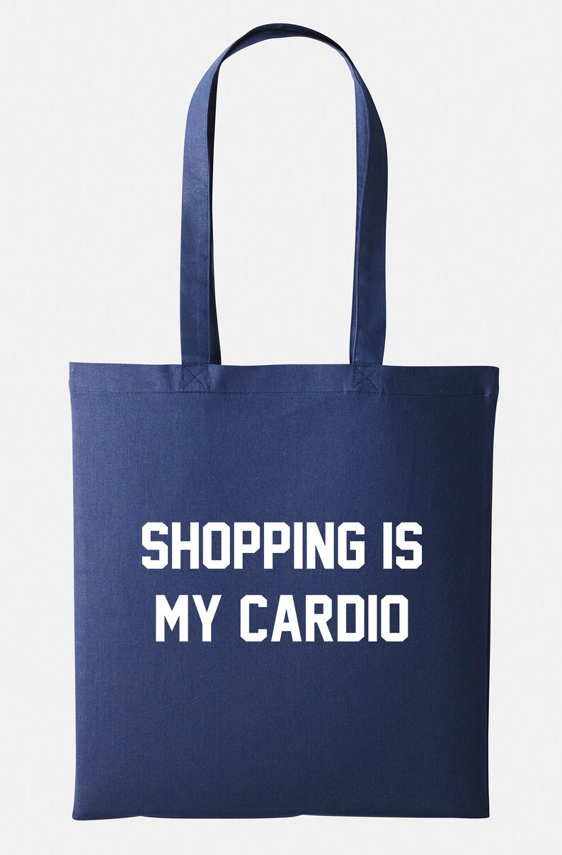 May include: A navy blue tote bag with white text that reads "SHOPPING IS MY CARDIO".